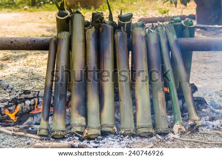 The sticky rice cooked with coconut milk roasting in the bamboo, Thailand traditional culture ancient method.
