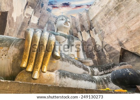 ancient architecture of Buddhist temples in Sukhothai Historical Park. Statue of Buddha Phra Achana at Wat Si Chum , Thailand