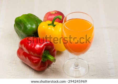 Fruit and vegetable juice in glasses and fresh fruits and vegetables on wooden background