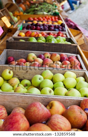 Crates of apples, plums and peaches are on display at a farmer\'s roadside stand market in northern Michigan. Crisp Michigan apples are always a treat in autumn
