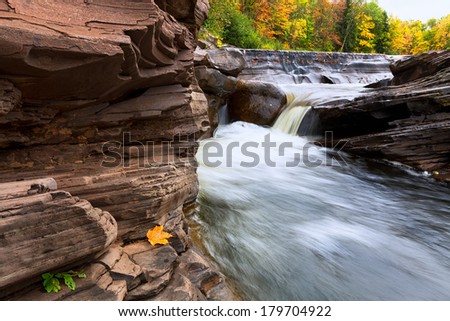Vibrant autumn colors provide a vivid background for Bonanza Falls in Michigan\'s Upper Peninsula