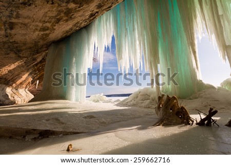 A stump is the highlight in this cavern behind the Grand Island ice curtains on Lake Superior, near Pictured Rocks National Lakeshore in Munising Michigan