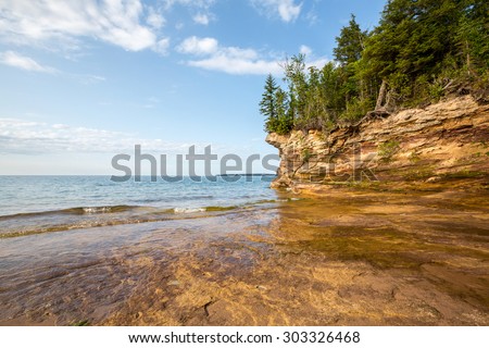 Lake Superior shoreline - Rocky outcroppings define the shoreline of Pictured Rocks National Lakeshore near Au Train Michigan. The Lake Superior shoreline is rugged and wild.