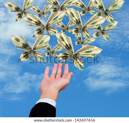 business man release origami butterfly from 100 dollar bill