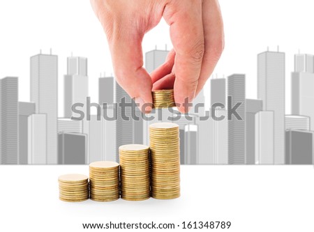hand stacking coin with city background