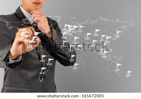 Man sketching flags on world map, concept of world-wide business.