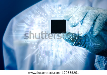 engineer holding electronics chip and electronics circuit glow in blue tone