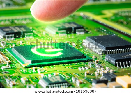 finger touching  glow start symbol on  microprocessor