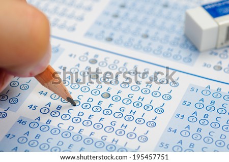 hand filling out answers to standard answer sheet