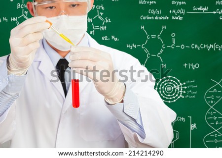 scientist mixing chemical substance with chalkboard background