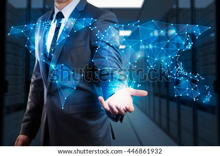 businessman showing  global network mesh with server room background