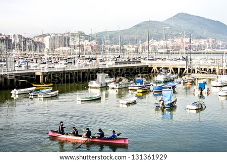 GETXO, SPAIN - FEBRUARY 16: A canoe training in the port of Getxo that it is celebrated in the month of February. February 16, 2013 in Getxo, Basque Country, Spain