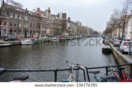AMSTERDAM, HOLLAND - APRIL 1: A view of the canal of Amsterdam that has hundred kilometres of canals dug in the 17th century during the Dutch Golden Age. April 1, 2013 in Amsterdam, Holland