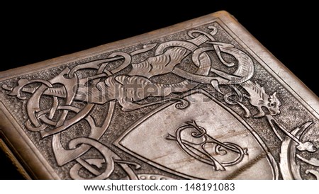 Old leather bound book with a dragon on the cover