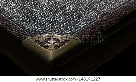 Old leather bound book with Fleur-de-lis on the corner