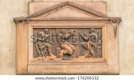Art Deco inspired Relief of a scientist next to a microscope holding distillation equipment, behind him is an old man and in front a young athlete, symbolizing eternal youth through science.