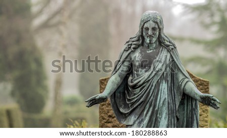 Cemetery Jesus statue with foggy background