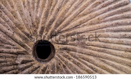 Stone mill wheel with spiral pattern grinder