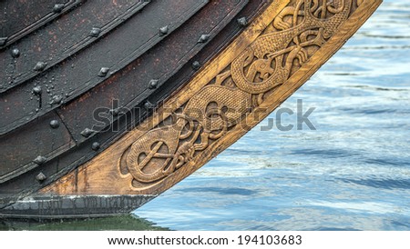 Viking ship bow keel with wood carving ornaments near the waterline