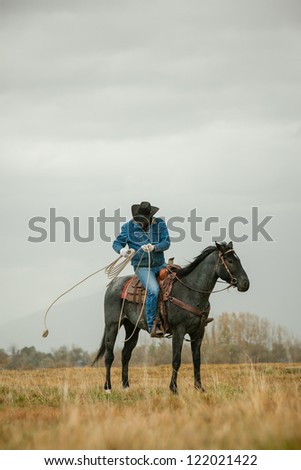 Cowboy wrapping up lasso after use