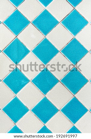 Blue and white of diamonds pattern tile wall.