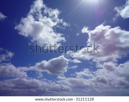 Bright sun in the sky with clouds