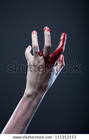 Bloody zombie hand, extreme body-art, studio shot