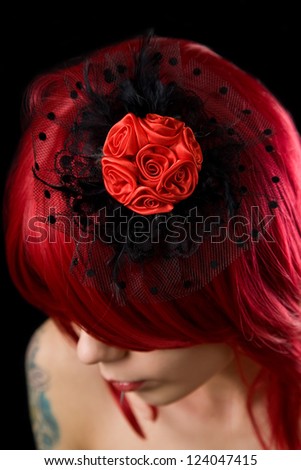 Red haired gothic girl with black feather hair fascinator and red roses