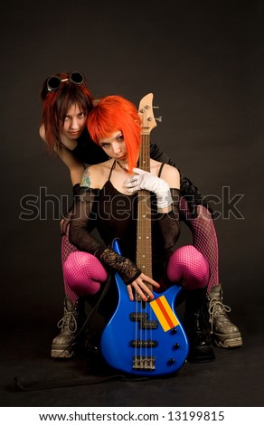Rock girls with bass guitar isolated in studio