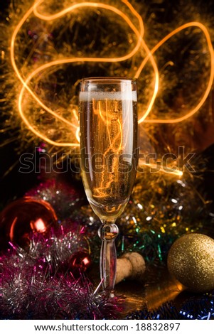 New Year card with champagne glass on holiday background