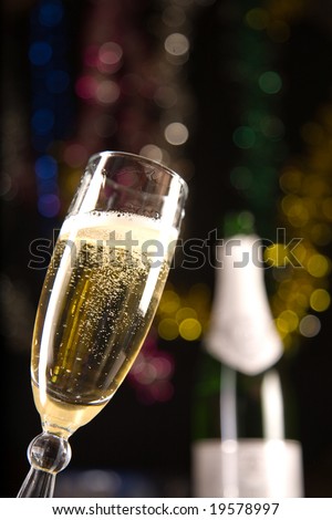 Champagne glass, blurred bottle on background