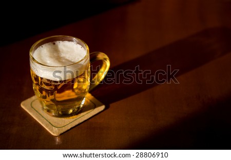 Beer mug over wood background