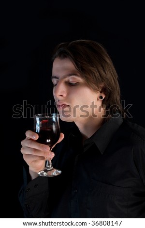 stock photo : Handsome vampire with glass of wine or blood, Halloween theme