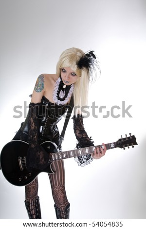stock photo Sexy gothic girl playing guitar studio shot over white 