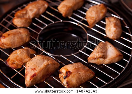 Tasty grilled chicken meat on gas grill