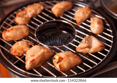 Cooking tasty grilled chicken on gas grill