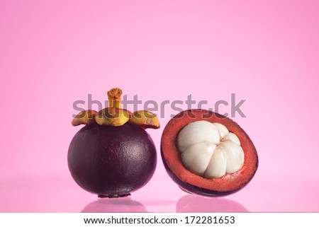 Tropical mangosteen fruits, queen of fruits, studio shot on pink background