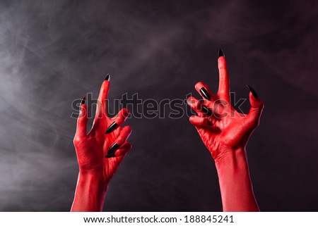 Creepy red devil hands with black sharp nails, Halloween theme