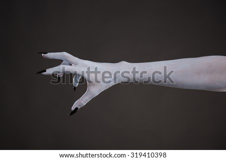 Scary pale skin hand with black nails, body art for Halloween