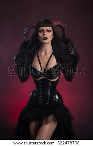 Sexy female demon in fetish costume, Halloween theme