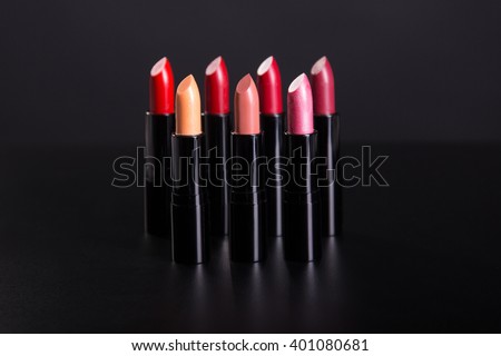 Set of lipsticks in red and natural colors, studio shot on black background