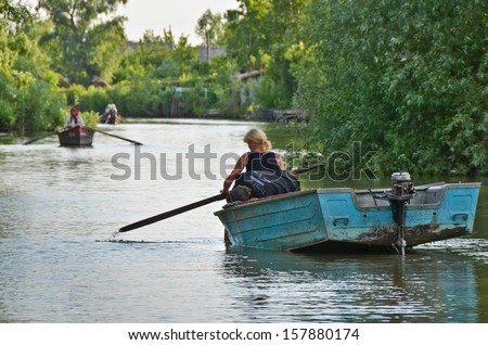 VILKOVO, UKRAINE - May 19: Danube delta. Undefined woman floating in a boat. Vilkovo-city on the water at the delta of Danube - the European Union\'s longest river, on May 19, 2012 in Vilkovo