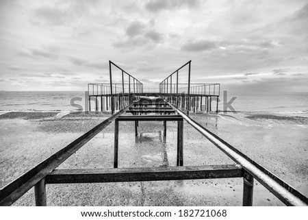 Lines - old steel pier construction at the ocean landscape