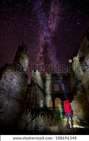 X-Files explorer - alone man on ruins with night starry sky and milky way