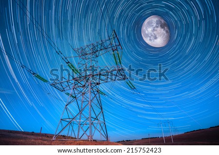 Electricity power poles on night sky and star tails moon