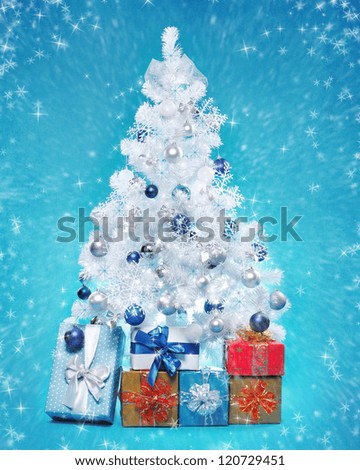 White decorated christmas tree on blue background
