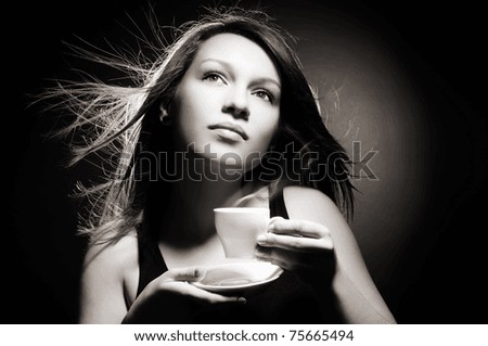 Young girl drinking a cup of coffee black and white shot