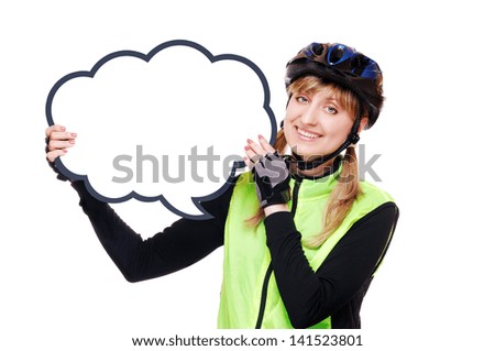 Happy cyclist girl in helmet and green vest holding the blank board as speaking bubble