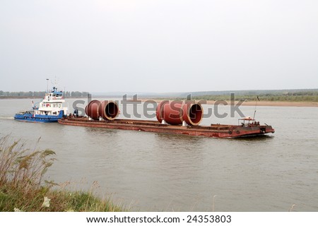industrial cargo transportation on river by ship with barge