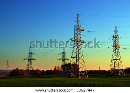 sunset landscape with electricity cable communication towers